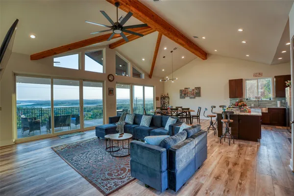 a living room with furniture a flat screen tv and a large window