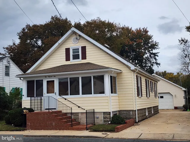 a view of small white house with large windows