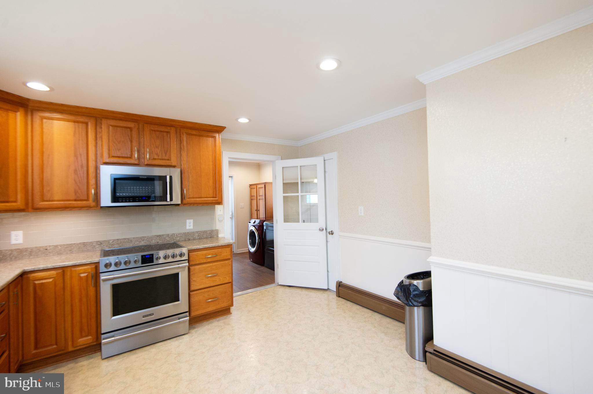 409 Bayly Avenue Cambridge, MD 21613 - Photo 12 of 54 a kitchen with a stove and a microwave