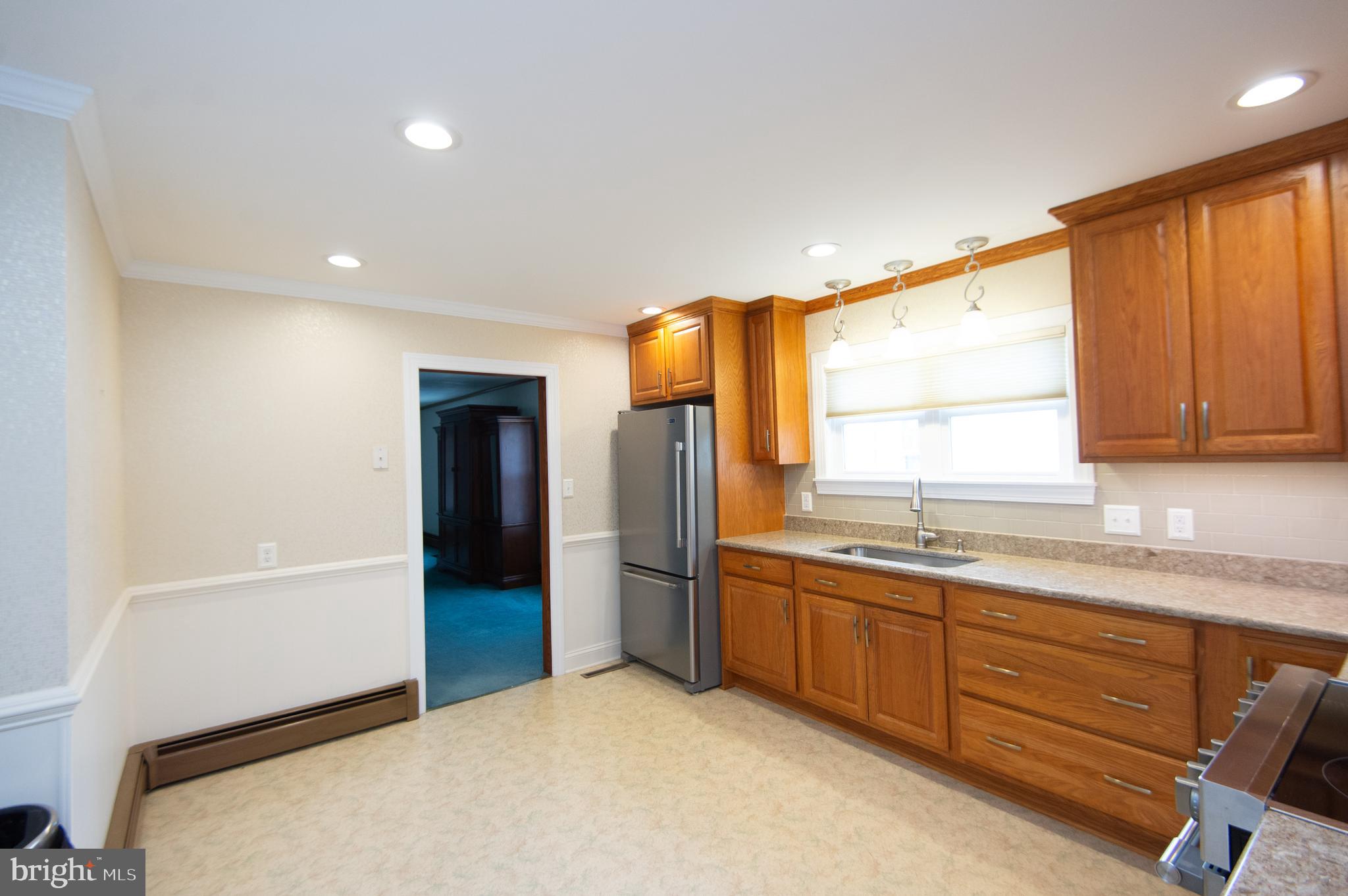 409 Bayly Avenue Cambridge, MD 21613 - Photo 13 of 54 a kitchen with stainless steel appliances granite countertop a refrigerator and a sink