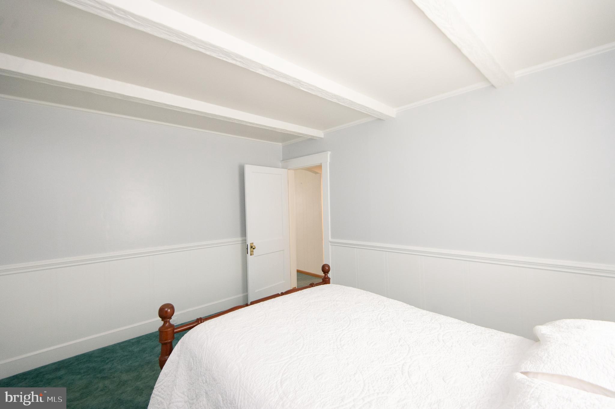 409 Bayly Avenue Cambridge, MD 21613 - Photo 20 of 54 a bedroom with a bed and a wall painting