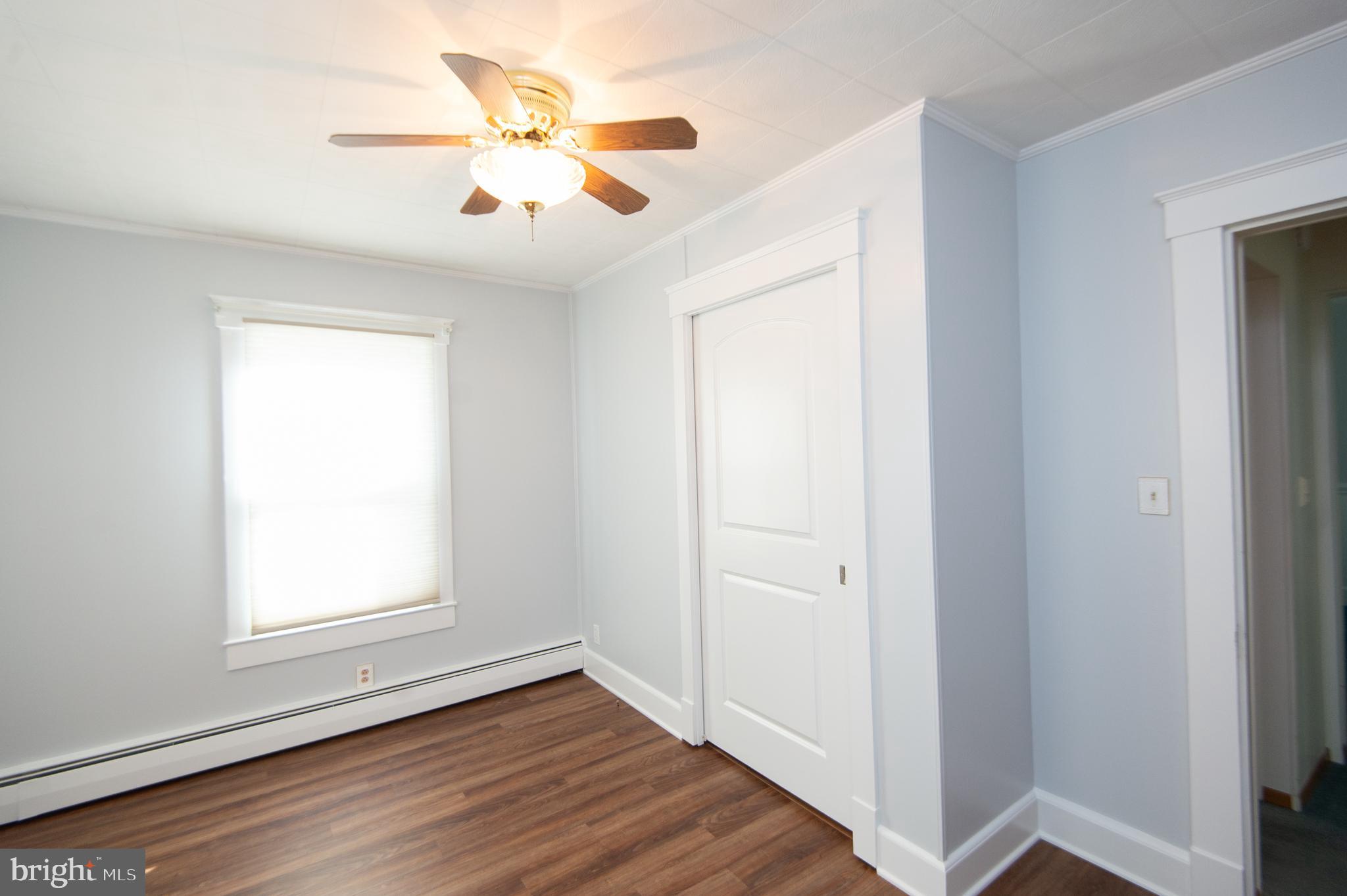 409 Bayly Avenue Cambridge, MD 21613 - Photo 25 of 54 a view of an empty room with wooden floor and a window