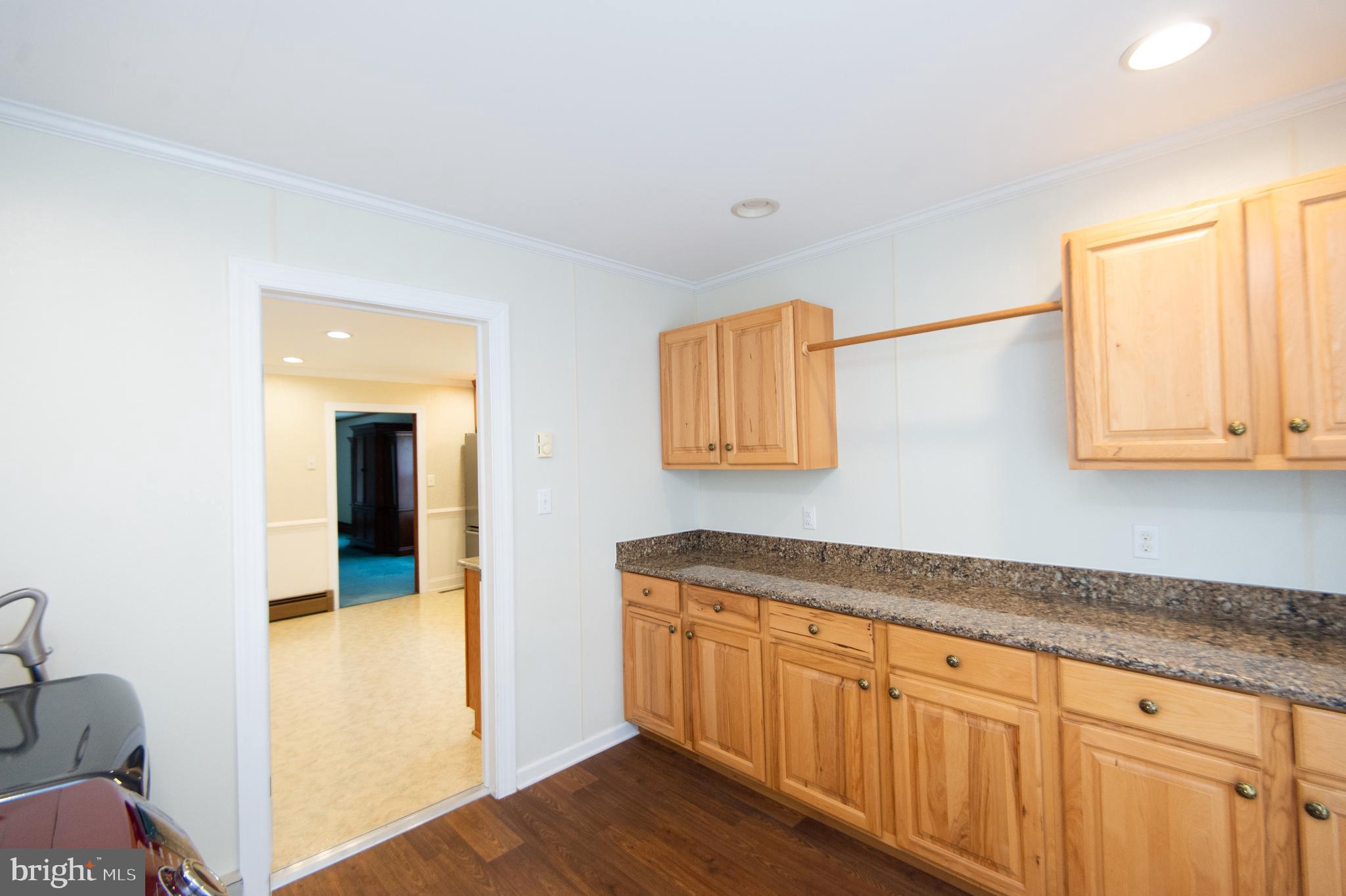 409 Bayly Avenue Cambridge, MD 21613 - Photo 31 of 54 a hallway with granite countertop wooden floor