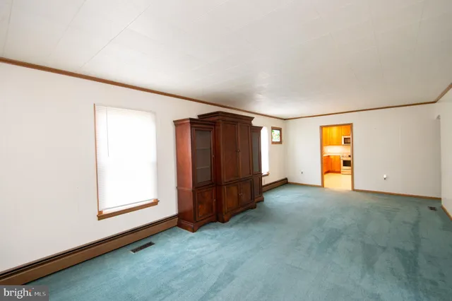 an empty room with closet and mirror