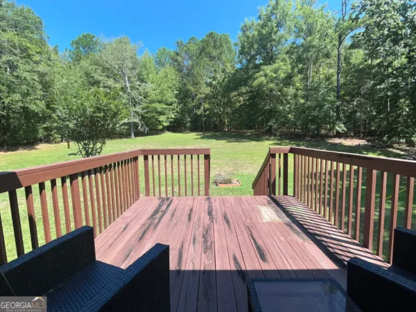 a view of balcony with wooden floor and outdoor seating
