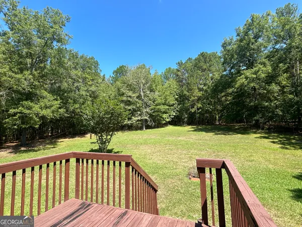 a view of a wooden deck with a yard