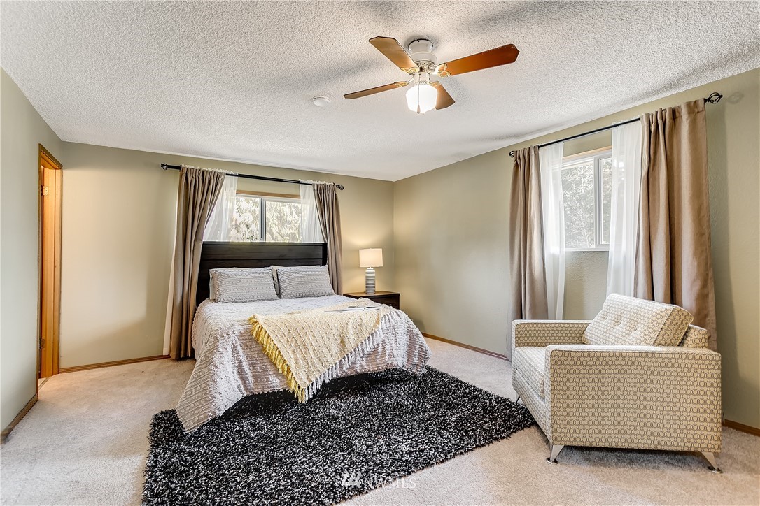 16404 Southeast 135th Street Renton, WA 98059 - Photo 14 of 22 a bedroom with a large bed and a couch