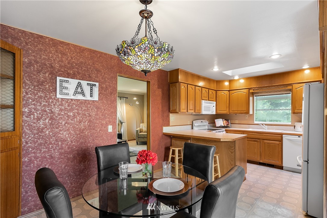 16404 Southeast 135th Street Renton, WA 98059 - Photo 7 of 22 a kitchen with stainless steel appliances granite countertop a sink and a stove