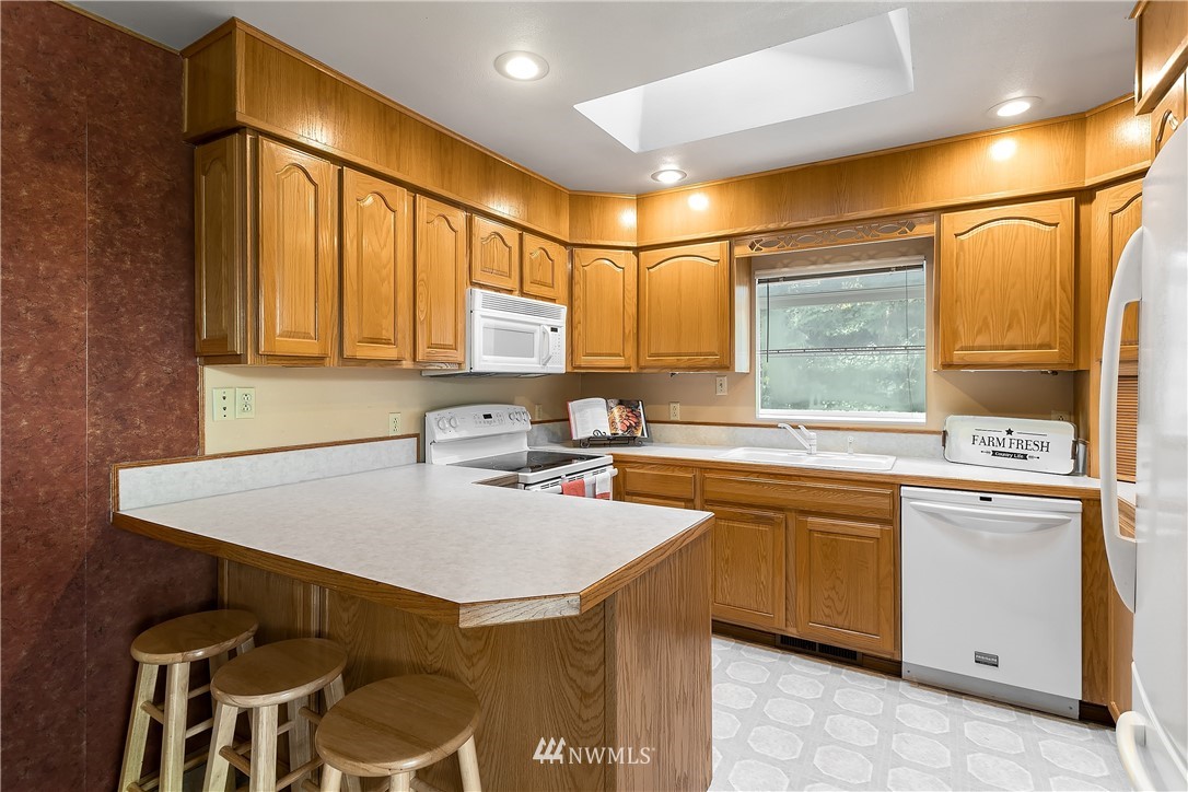 16404 Southeast 135th Street Renton, WA 98059 - Photo 8 of 22 a kitchen with a sink and cabinets
