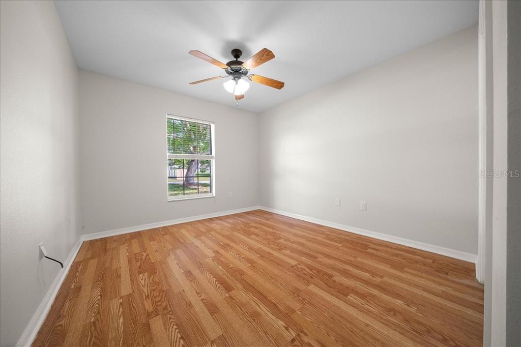 234 Locust Lane Ocala, FL 34472 - Photo 70 of 71 a view of empty room with wooden floor and fan