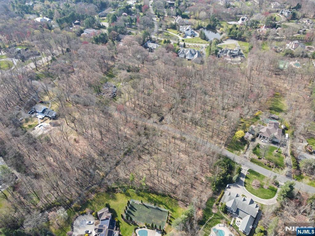18 Wildwood Road Saddle River, NJ 07458 - Photo 3 of 3 a backyard of a house with a yard and outdoor seating