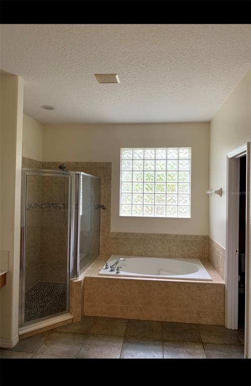 761 Broadoak Loop Sanford, FL 32771 - Photo 8 of 22 a bathroom with a bathtub and a shower