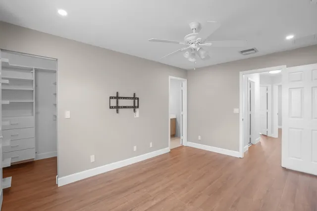 a view of an empty room with wooden floor