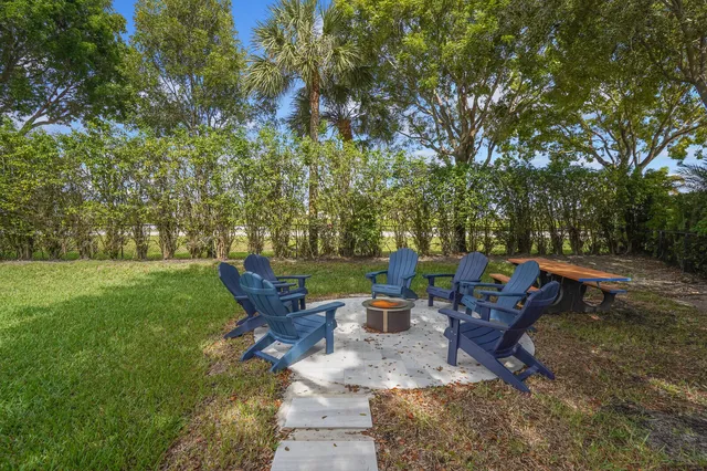 a view of a backyard with sitting area