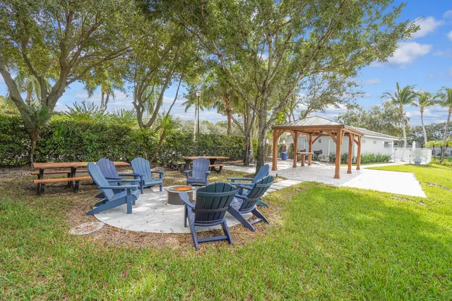a view of a patio with table and chairs under an umbrella