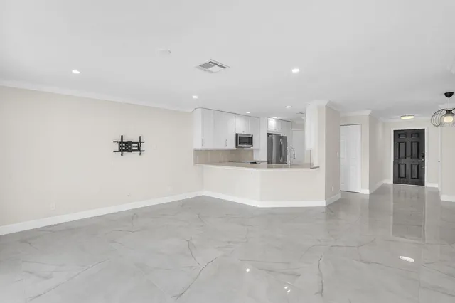 a view of a kitchen with a refrigerator and a sink