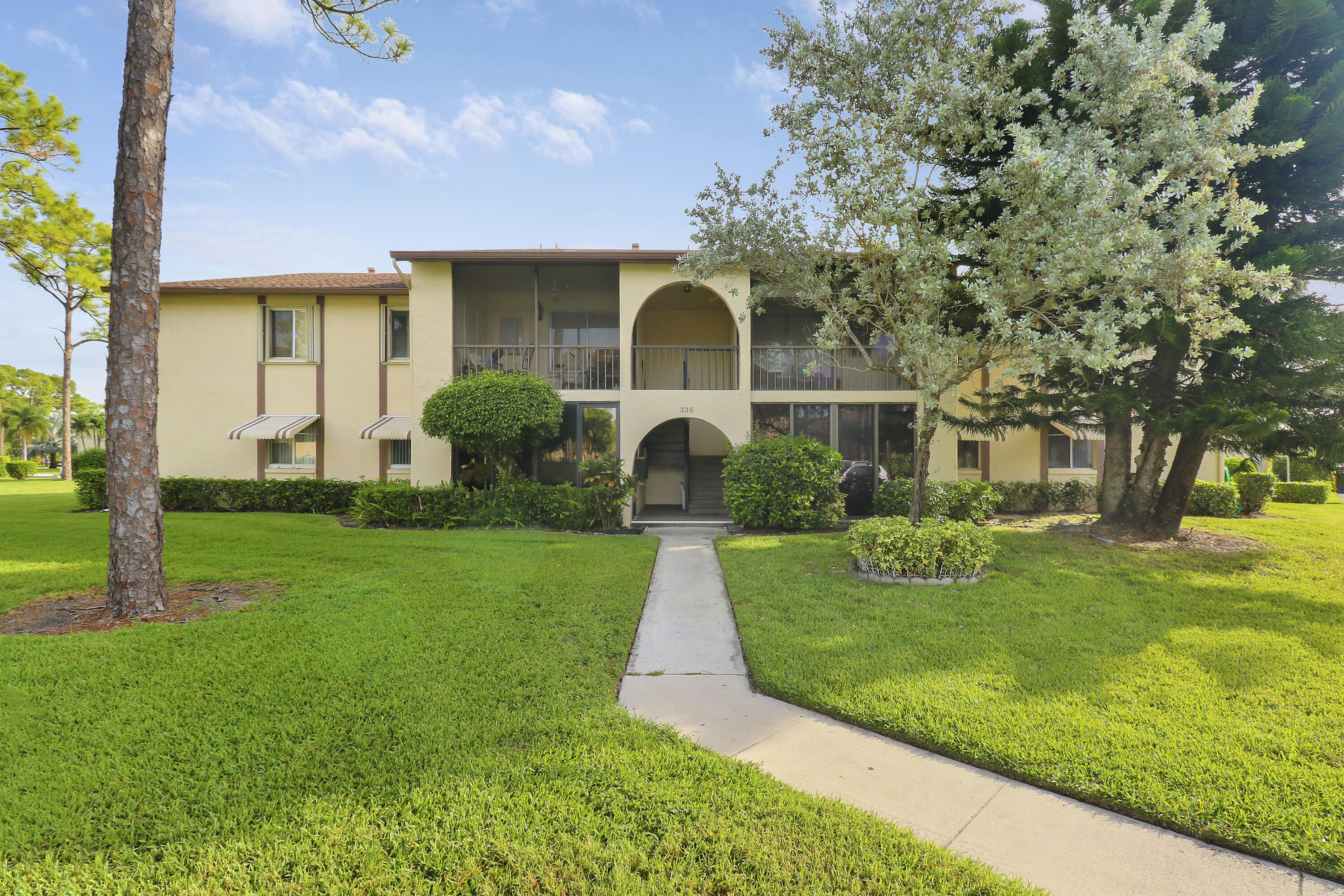 335 Knotty Pine Circle, Unit D1 Greenacres, FL 33463 - Photo 1 of 18 a front view of a house with garden