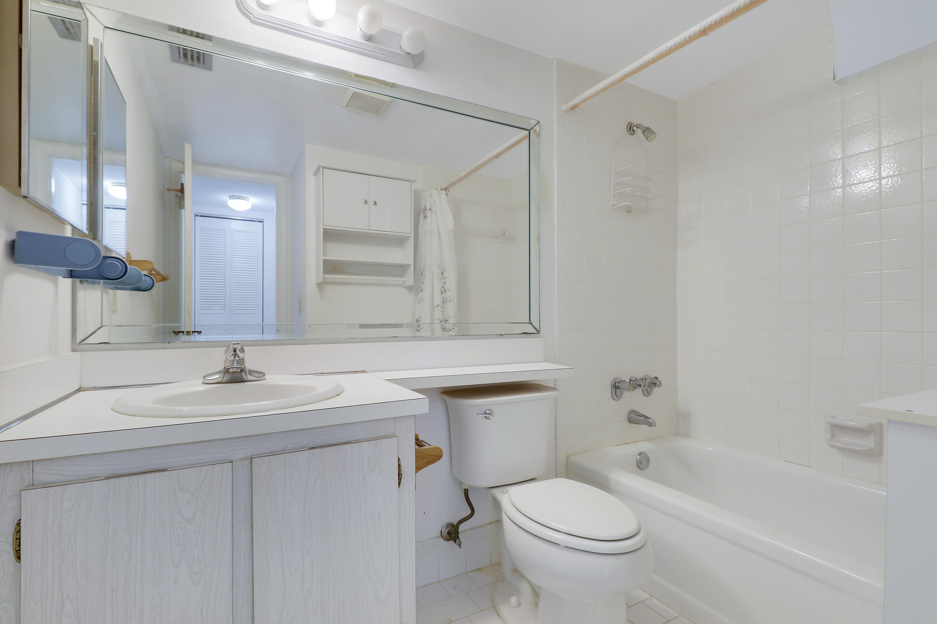 335 Knotty Pine Circle, Unit D1 Greenacres, FL 33463 - Photo 12 of 18 a bathroom with a sink toilet and a mirror