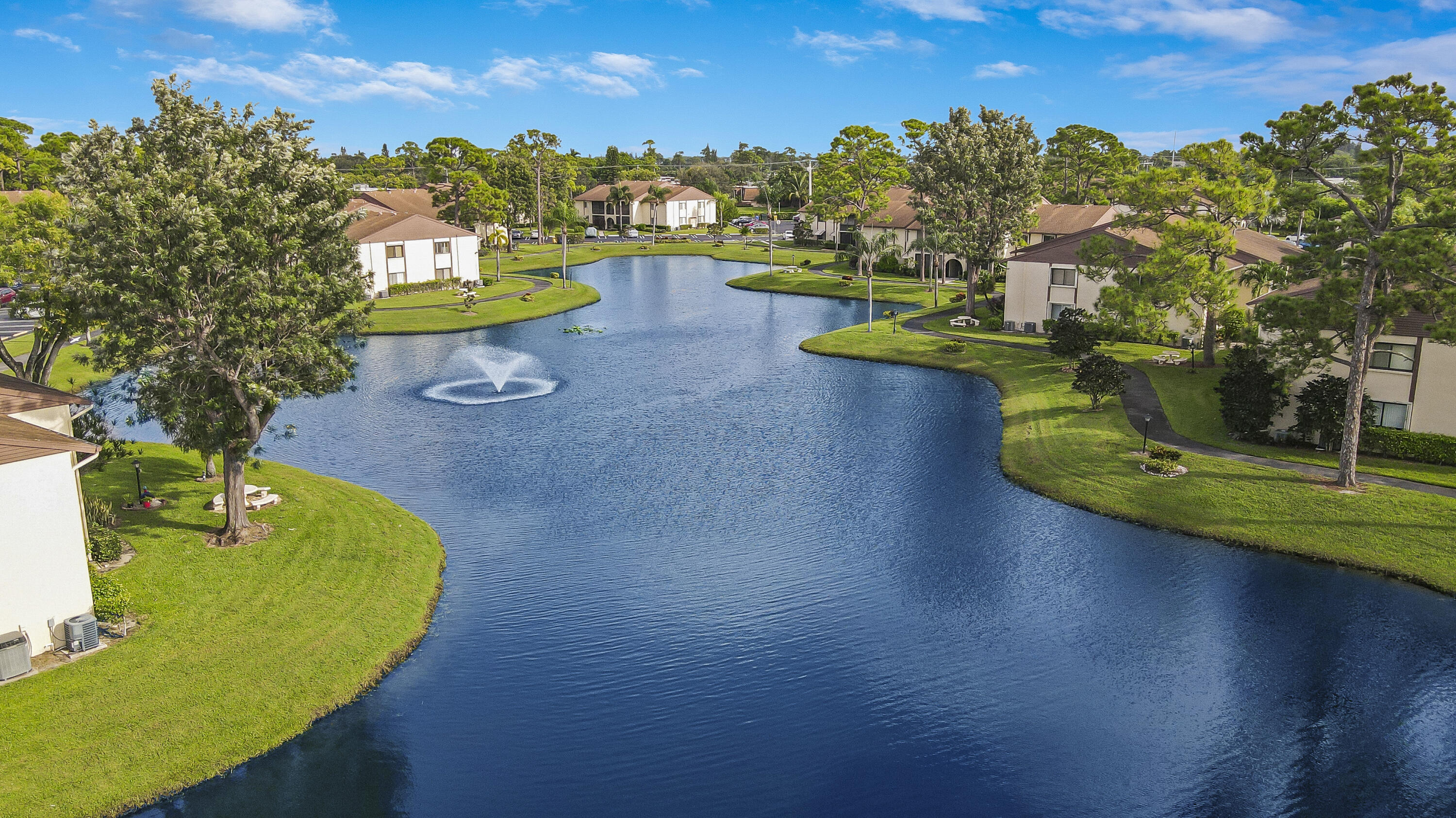 335 Knotty Pine Circle, Unit D1 Greenacres, FL 33463 - Photo 17 of 18 a view of a swimming pool with an outdoor space and seating area