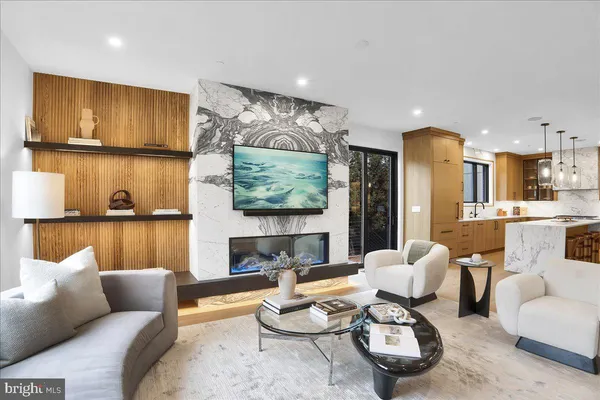 a living room with furniture and a kitchen view