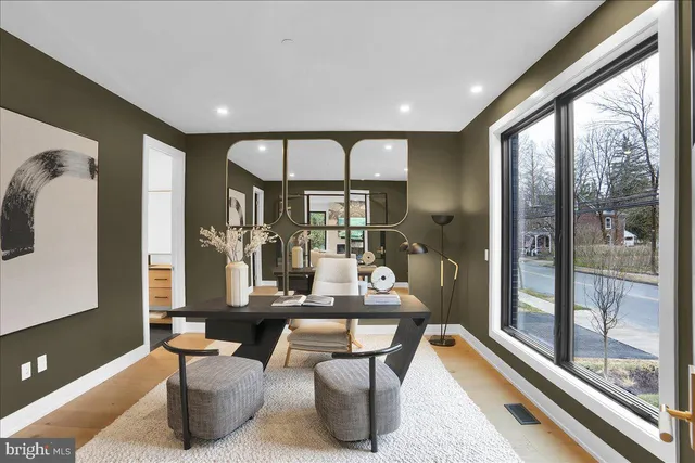 a dining room with furniture a large window and a rug