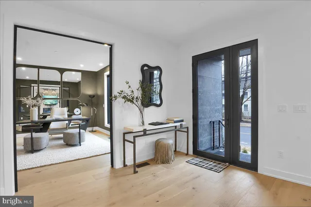 a view of a livingroom with furniture and floor to ceiling window