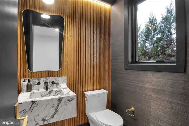 a dining room with wooden floor and white walls