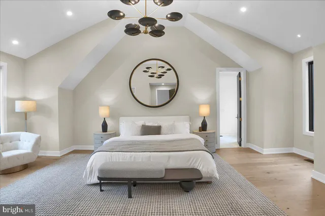 a bedroom with a large bed and a mirror