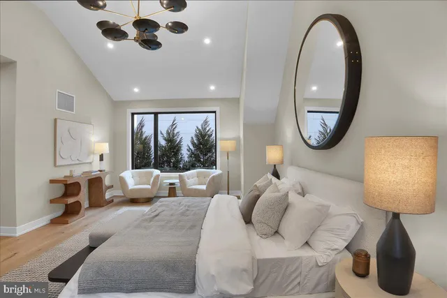 a bedroom with bed and a large mirror