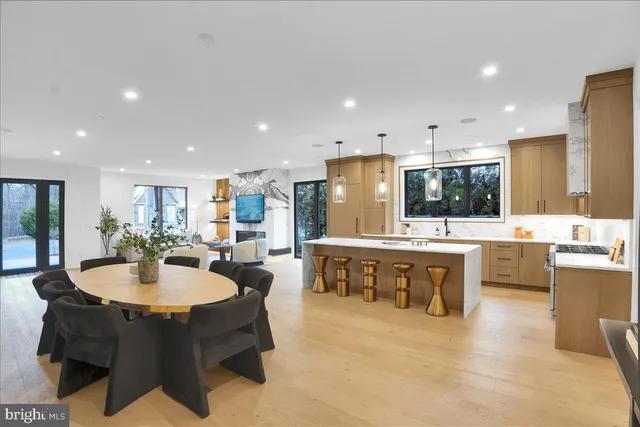 a large kitchen with a table and chairs