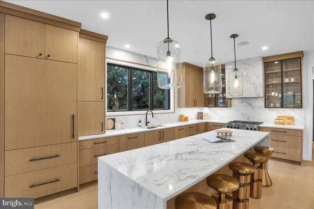 a kitchen with center island and stainless steel appliances