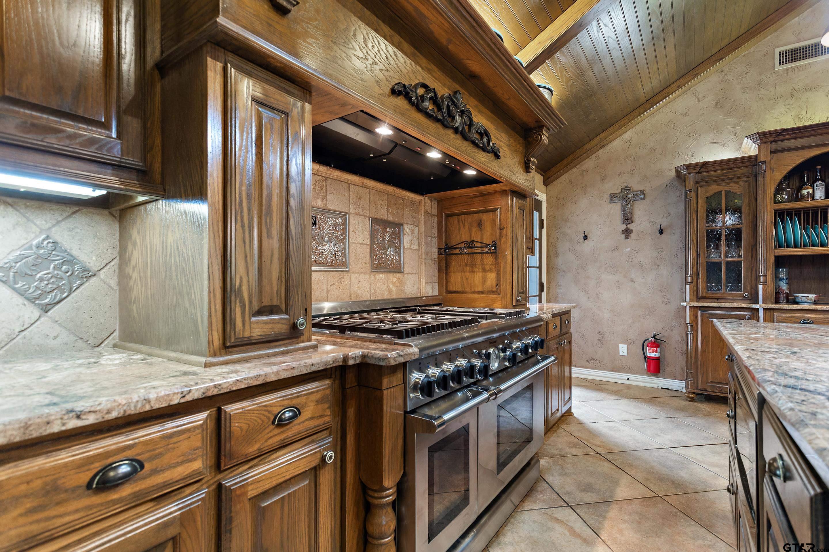 19678-c R 4125 C R 4125 Lindale, TX 75771 - Photo 11 of 48 a kitchen with stainless steel appliances granite countertop a stove and a sink