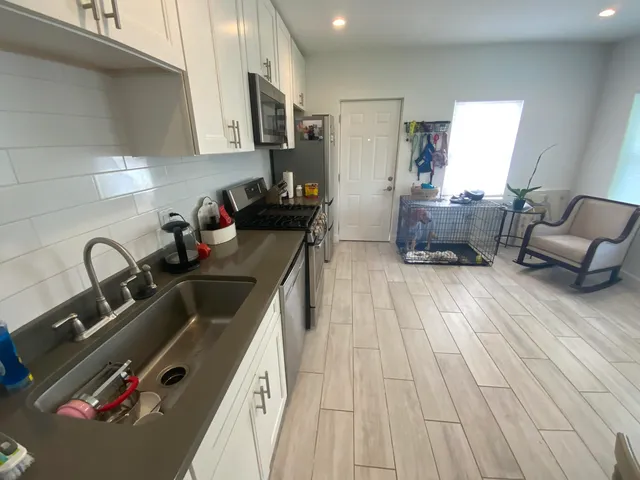 a kitchen with a sink appliances and cabinets