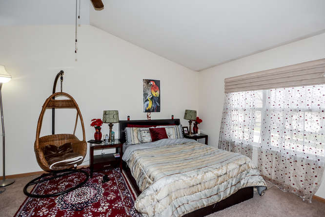 796 Teasel Lane Aurora, IL 60504 - Photo 18 of 37 a bedroom with bed and a window