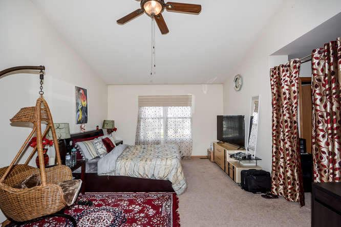 796 Teasel Lane Aurora, IL 60504 - Photo 19 of 37 a bedroom with furniture and a flat screen tv