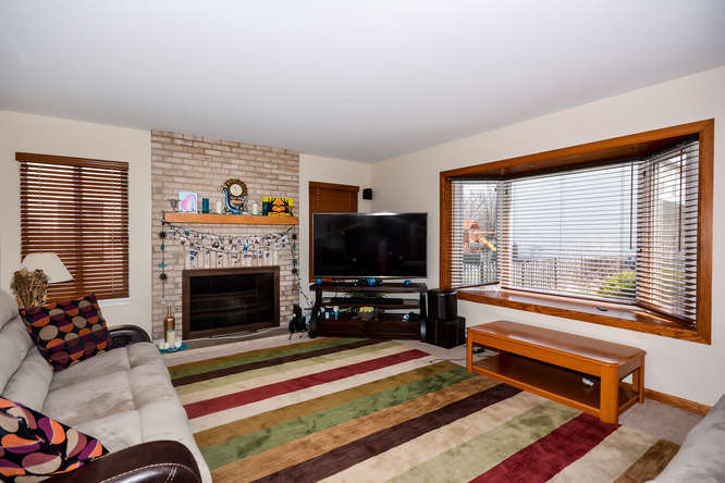 796 Teasel Lane Aurora, IL 60504 - Photo 5 of 37 a living room with furniture flat screen tv and a fireplace