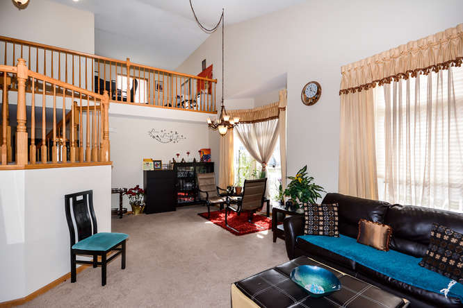 796 Teasel Lane Aurora, IL 60504 - Photo 10 of 37 a living room with furniture stairs and a window