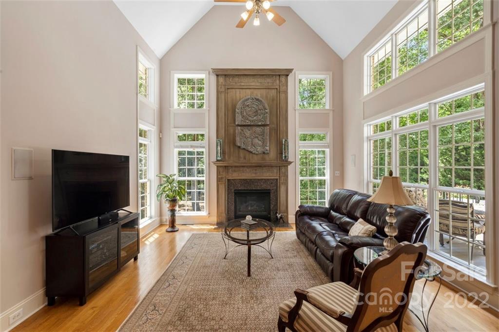 312 Devonport Drive Matthews, NC 28104 - Photo 13 of 48 a living room with furniture a fireplace and a flat screen tv