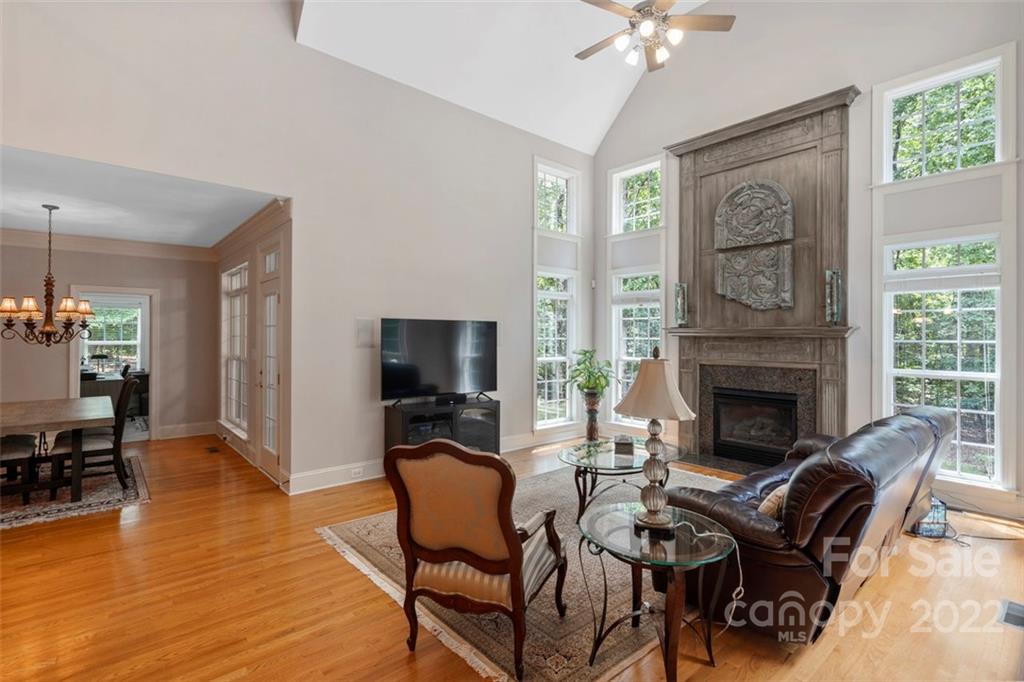 312 Devonport Drive Matthews, NC 28104 - Photo 15 of 48 a living room with furniture a fireplace and a flat screen tv