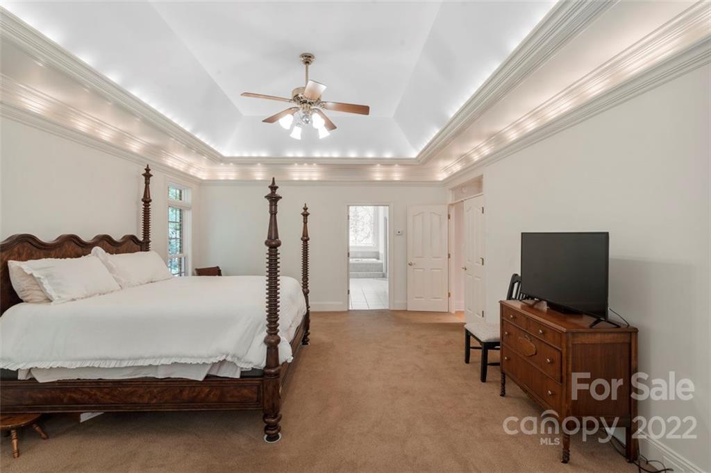 312 Devonport Drive Matthews, NC 28104 - Photo 25 of 48 a bedroom with furniture and a flat screen tv