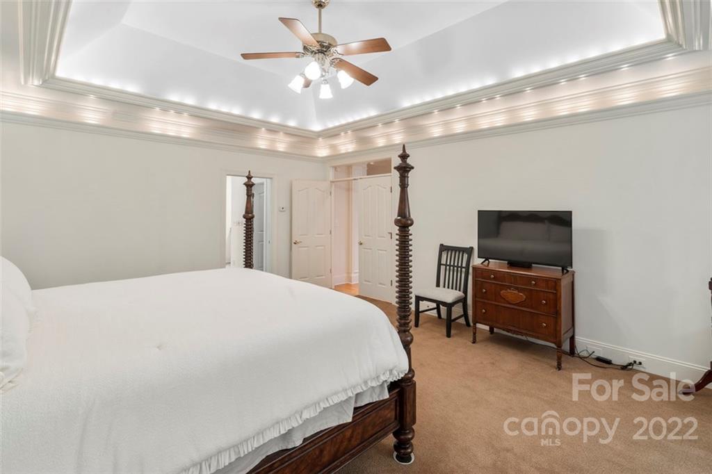 312 Devonport Drive Matthews, NC 28104 - Photo 26 of 48 a bedroom with a bed and a chandelier