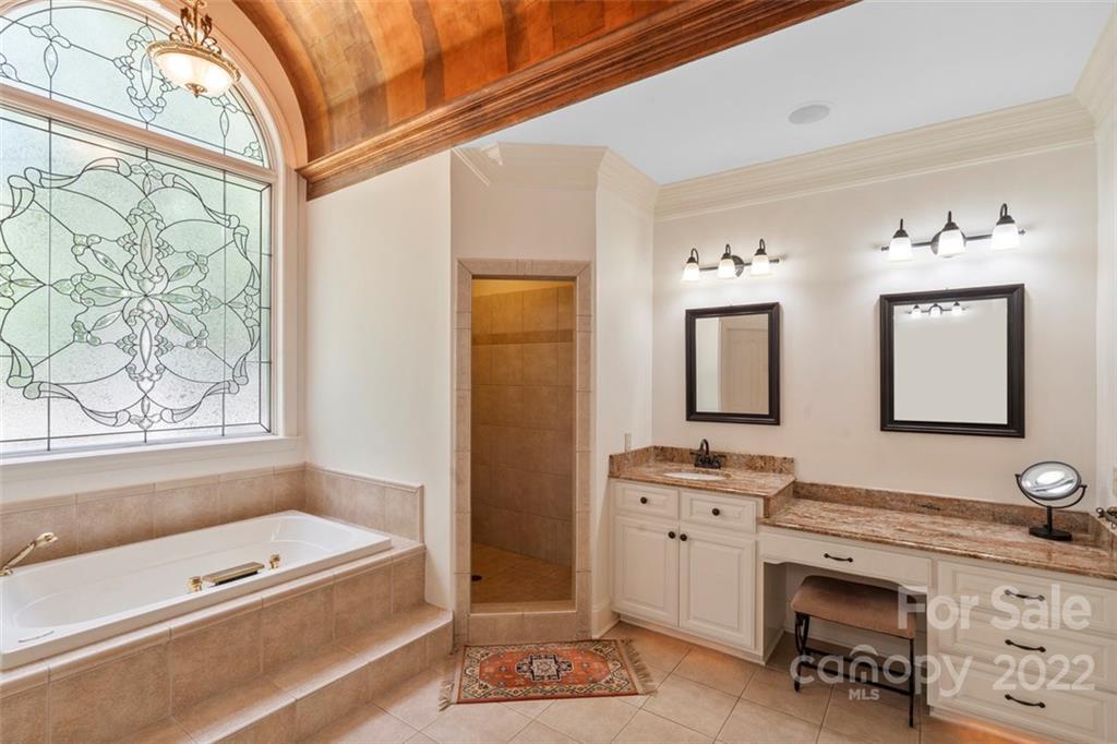 312 Devonport Drive Matthews, NC 28104 - Photo 30 of 48 a spacious bathroom with a tub sink and mirror