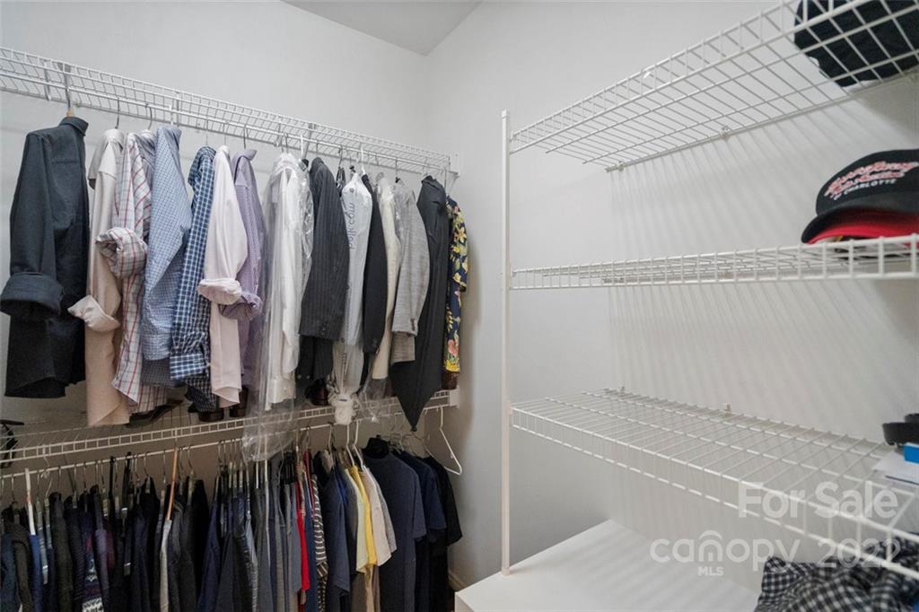 312 Devonport Drive Matthews, NC 28104 - Photo 32 of 48 a view of walk in closet with clothes and shoes