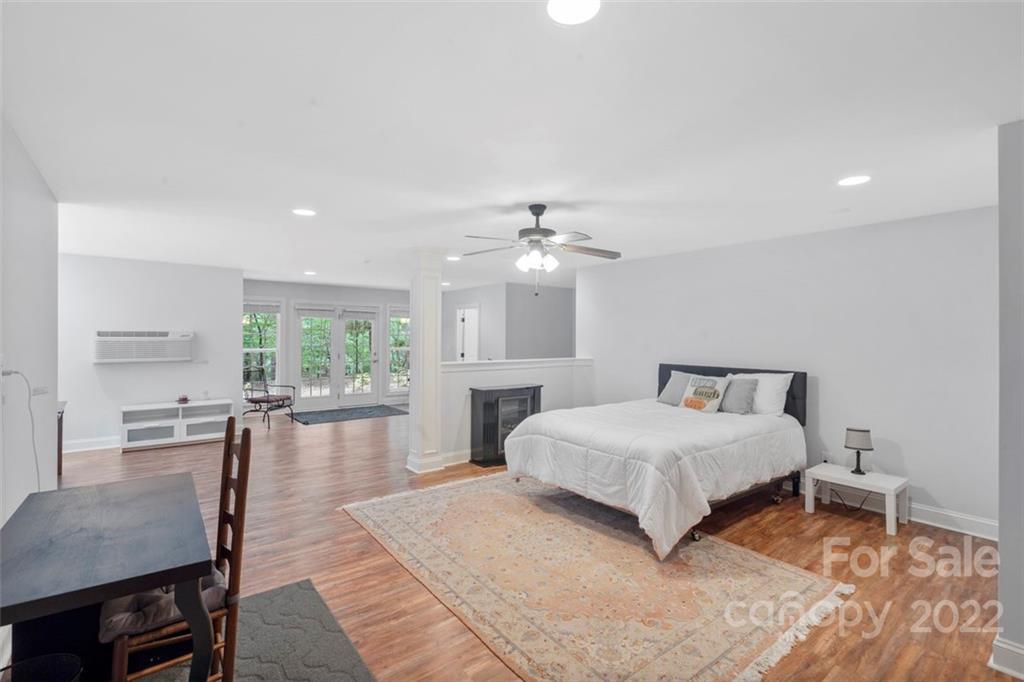 312 Devonport Drive Matthews, NC 28104 - Photo 34 of 48 a bedroom with a large bed a chandelier and a window