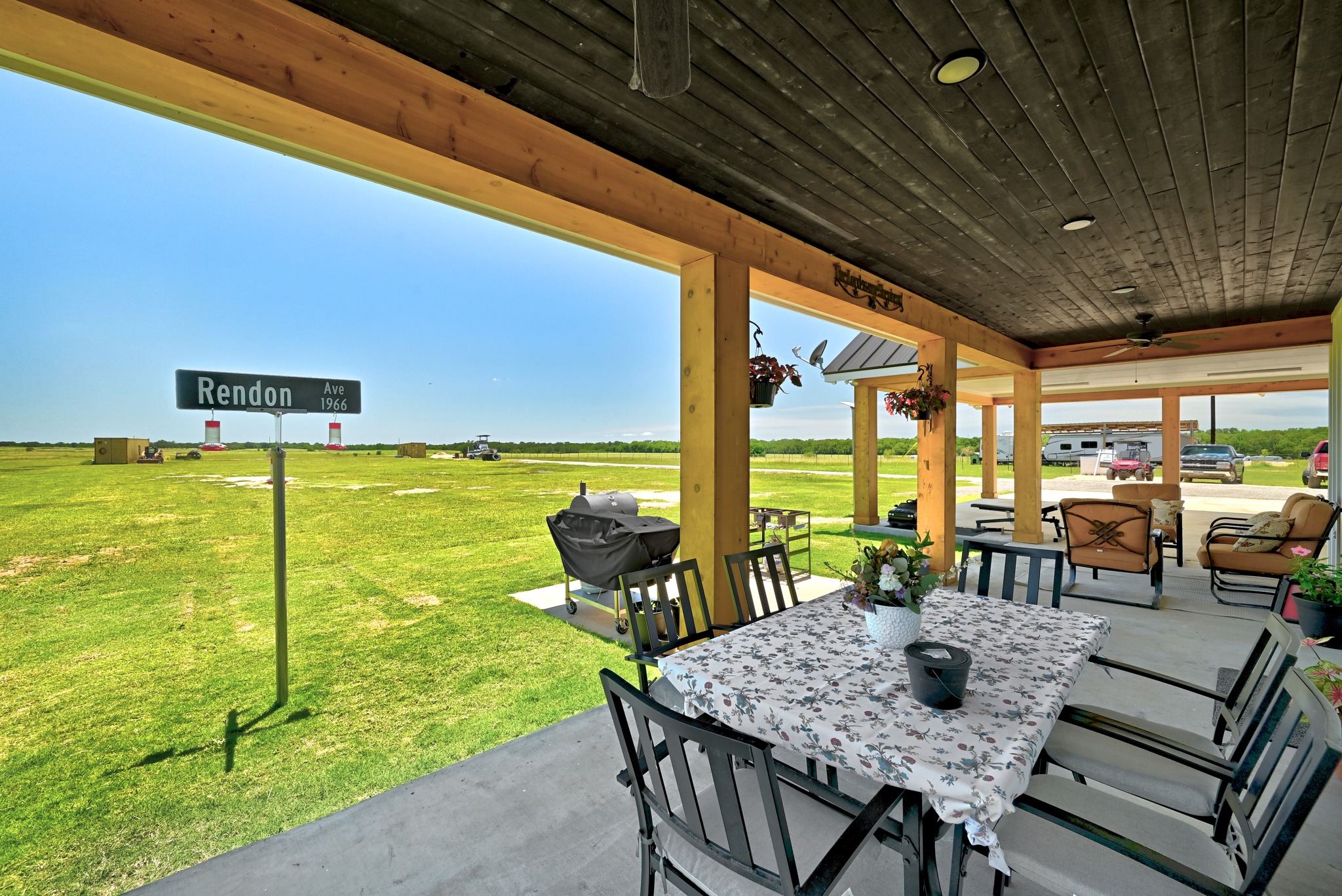 2889 Old McMahan Road Lockhart, TX 78644 - Photo 26 of 33 An inviting covered patio offers a tranquil outdoor living space with expansive views of the surrounding green landscape.