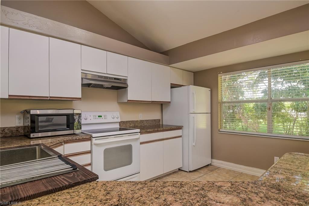 18422 Sunflower Road Fort Myers, FL 33967 - Photo 8 of 26 a kitchen with stainless steel appliances granite countertop a stove a refrigerator and a microwave