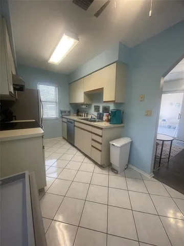 a kitchen with a sink a stove and cabinets