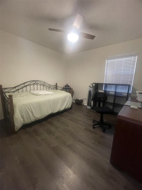 25068 Harbor View Road, Unit 3D Punta Gorda, FL 33980 - Photo 15 of 24 a spacious bedroom with a bed and a chandelier