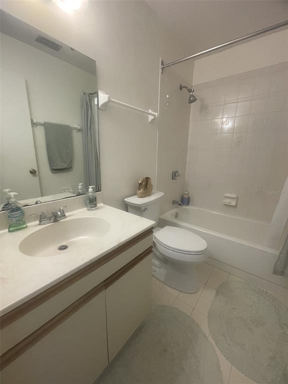 25068 Harbor View Road, Unit 3D Punta Gorda, FL 33980 - Photo 17 of 24 a bathroom with a double vanity sink toilet mirror and shower