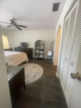 a bedroom with a bed and a mirror on dresser